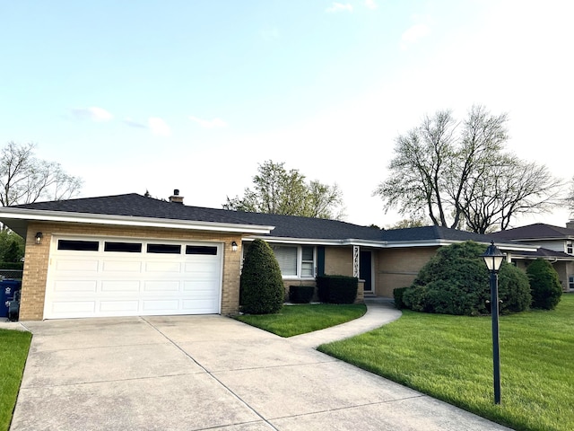 single story home featuring an attached garage, concrete driveway, a front lawn, and brick siding