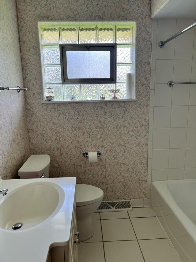 bathroom featuring tile patterned flooring, visible vents, vanity, toilet, and wallpapered walls