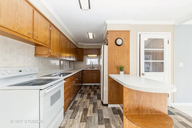 27569 N Beech St, Island Lake, IL 60042 - kitchen with white appliances, dark wood finished floors, a peninsula, light countertops, and brown cabinets