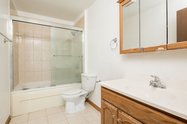 bathroom with tile patterned flooring, vanity, toilet, baseboards, and bath / shower combo with glass door