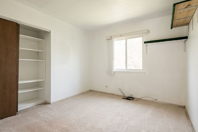 unfurnished bedroom featuring a closet and carpet flooring