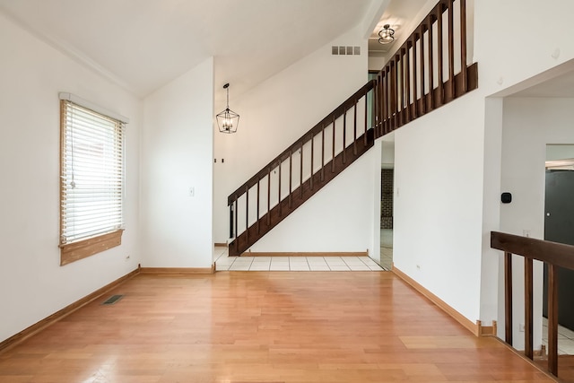 interior space featuring visible vents, wood finished floors, and stairway