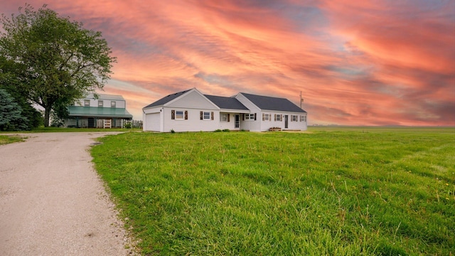 17594 N 2500 E Rd, Towanda, IL 61776 - view of front of home featuring dirt driveway, a garage, and a lawn