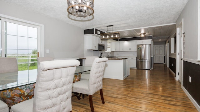 17594 N 2500 E Rd, Towanda, IL 61776 - dining room with wood finished floors, a chandelier, and a textured ceiling