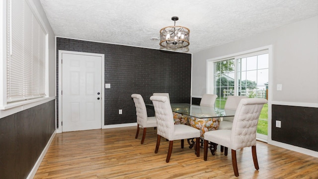 17594 N 2500 E Rd, Towanda, IL 61776 - dining space with a chandelier, light wood-style flooring, and a textured ceiling