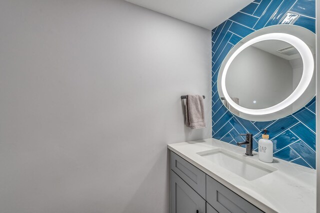 bathroom featuring backsplash, tile walls, and vanity