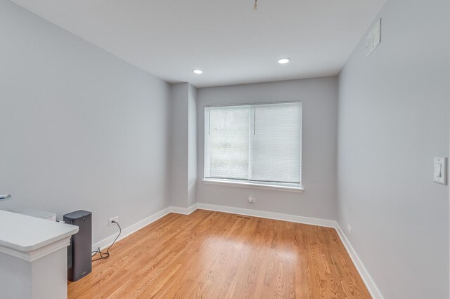 unfurnished room with visible vents, recessed lighting, baseboards, and light wood-type flooring