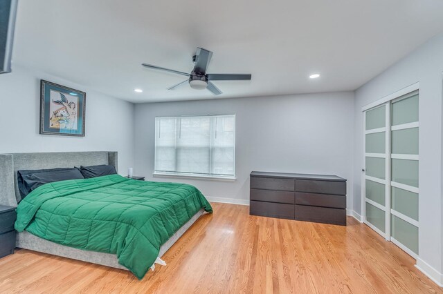 bedroom featuring ceiling fan, wood finished floors, baseboards, a closet, and recessed lighting