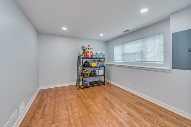 interior space featuring recessed lighting, baseboards, wood finished floors, visible vents, and electric panel