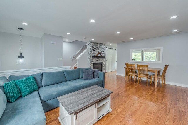living room with light wood-style floors, stairway, and recessed lighting