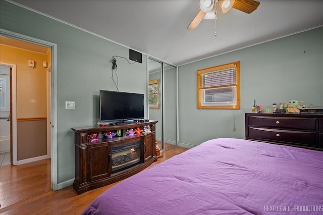 3005 Starling Ln, Rolling Meadows, IL 60008 - bedroom featuring wood finished floors, baseboards, a closet, crown molding, and ceiling fan