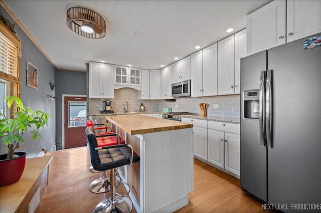 3005 Starling Ln, Rolling Meadows, IL 60008 - kitchen featuring stainless steel appliances, butcher block counters, light wood-style flooring, white cabinetry, and backsplash
