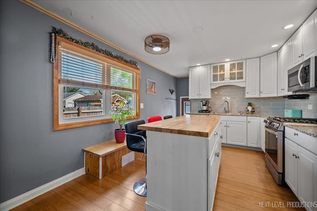 3005 Starling Ln, Rolling Meadows, IL 60008 - kitchen with appliances with stainless steel finishes, butcher block countertops, tasteful backsplash, white cabinets, and a sink