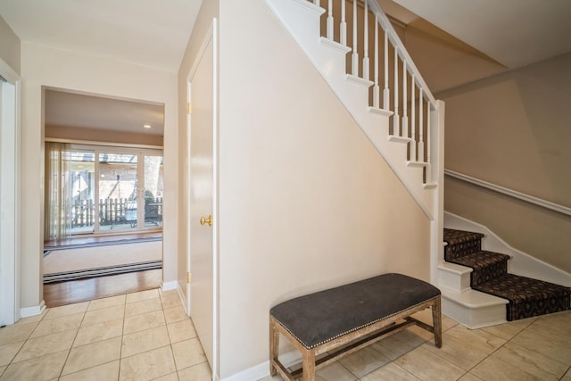 staircase with baseboards and tile patterned floors