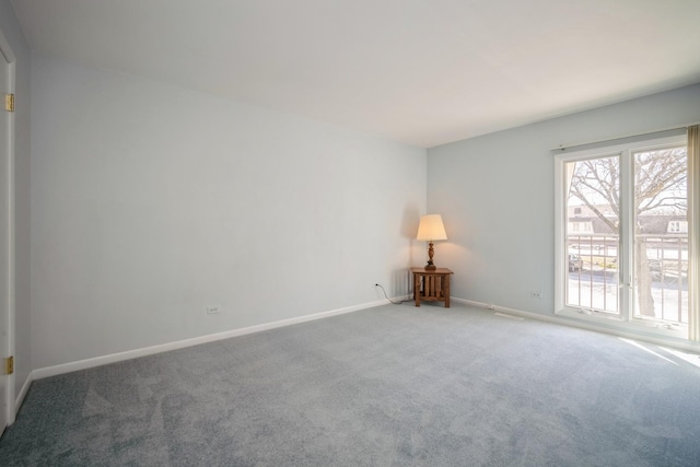 empty room with carpet flooring and baseboards