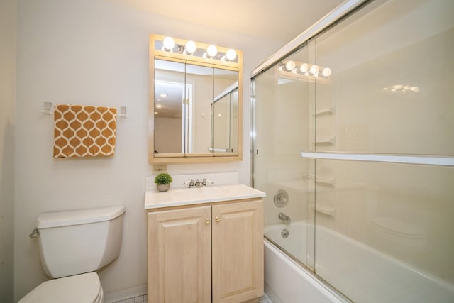 bathroom with vanity, bath / shower combo with glass door, and toilet