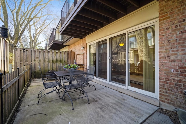 view of patio with outdoor dining area and fence