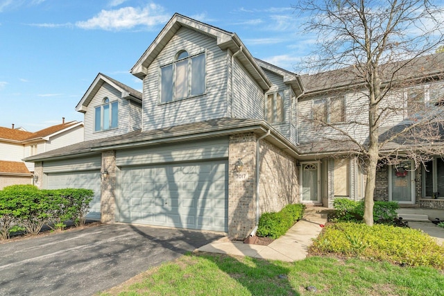 7017 Plymouth Ct, Tinley Park, IL 60477 - view of front facade with aphalt driveway, a garage, and brick siding