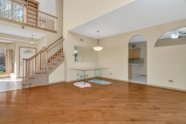 7017 Plymouth Ct, Tinley Park, IL 60477 - interior space featuring stairs, wood finished floors, visible vents, ceiling fan, and baseboards