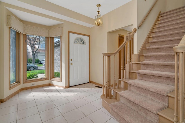 7017 Plymouth Ct, Tinley Park, IL 60477 - foyer entrance with stairway, an inviting chandelier, baseboards, and light tile patterned floors