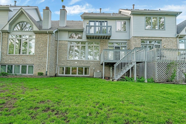 7017 Plymouth Ct, Tinley Park, IL 60477 - rear view of house featuring a yard, a balcony, brick siding, and a deck