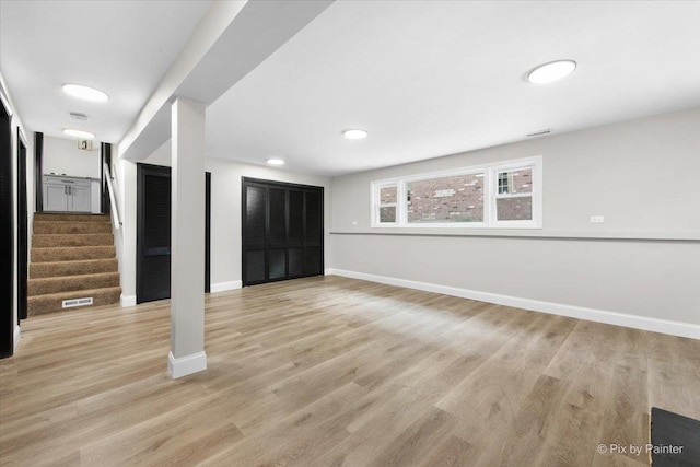 4430 Roslyn Rd, Downers Grove, IL 60515 - basement with baseboards, light wood-style floors, visible vents, and stairway