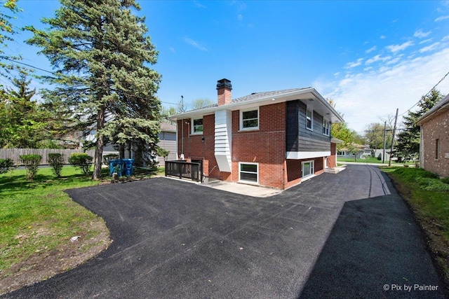 4430 Roslyn Rd, Downers Grove, IL 60515 - rear view of house with fence, brick siding, and a chimney