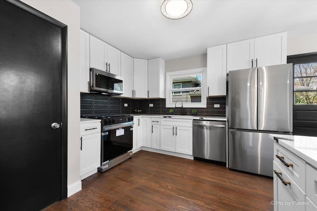 4430 Roslyn Rd, Downers Grove, IL 60515 - kitchen with a sink, stainless steel appliances, tasteful backsplash, white cabinetry, and dark wood-style floors