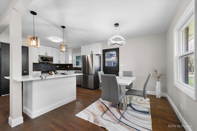 4430 Roslyn Rd, Downers Grove, IL 60515 - kitchen with white cabinets, appliances with stainless steel finishes, dark wood-style flooring, and tasteful backsplash
