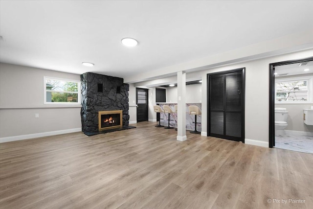 4430 Roslyn Rd, Downers Grove, IL 60515 - unfurnished living room with wood finished floors, a fireplace, baseboards, and a healthy amount of sunlight