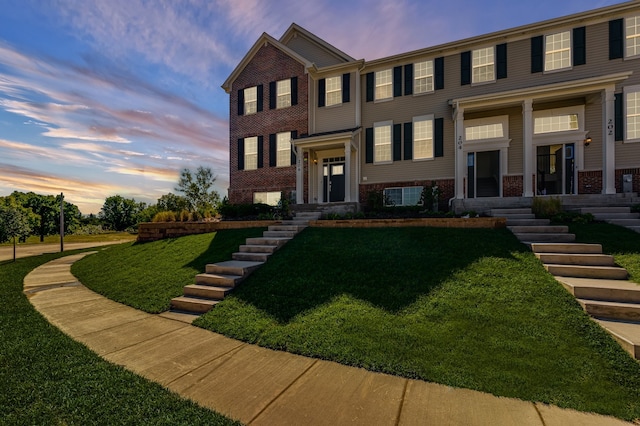 2109 Neubauer Cir Unit 1105, Lindenhurst, IL 60046 - view of front of property with brick siding and a lawn