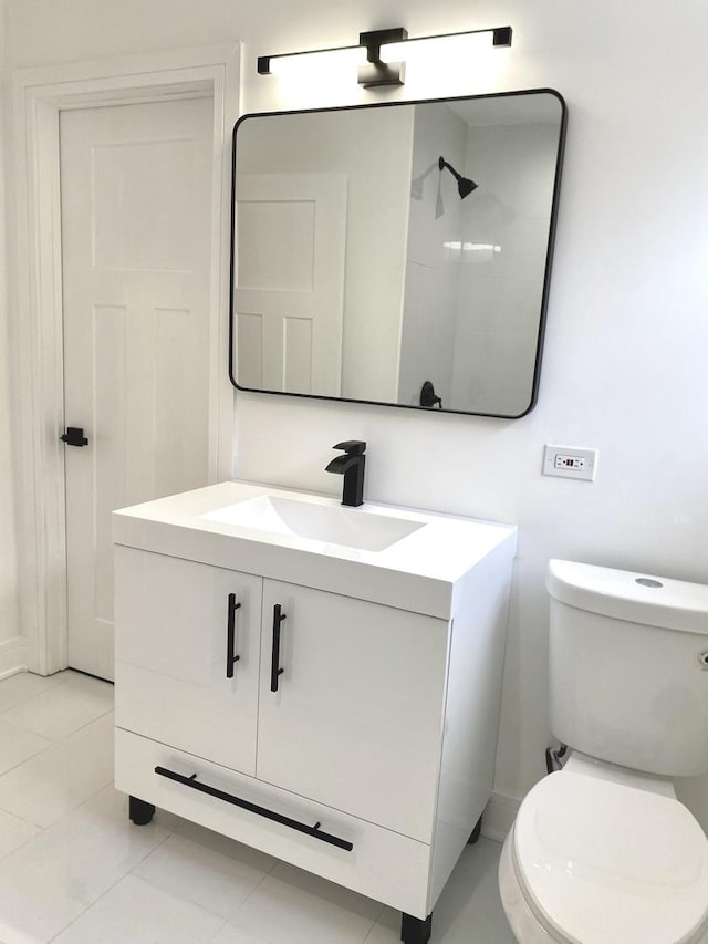 bathroom with vanity, tile patterned flooring, and toilet