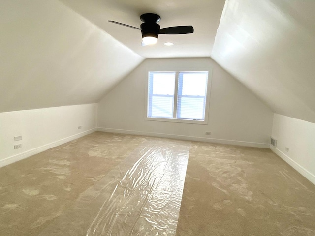 additional living space featuring carpet floors, baseboards, ceiling fan, and lofted ceiling