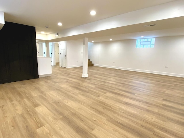 basement featuring recessed lighting, baseboards, and light wood-type flooring
