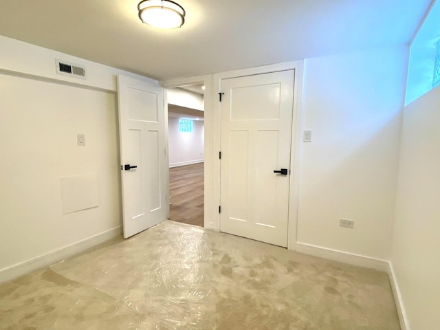 empty room featuring baseboards and visible vents