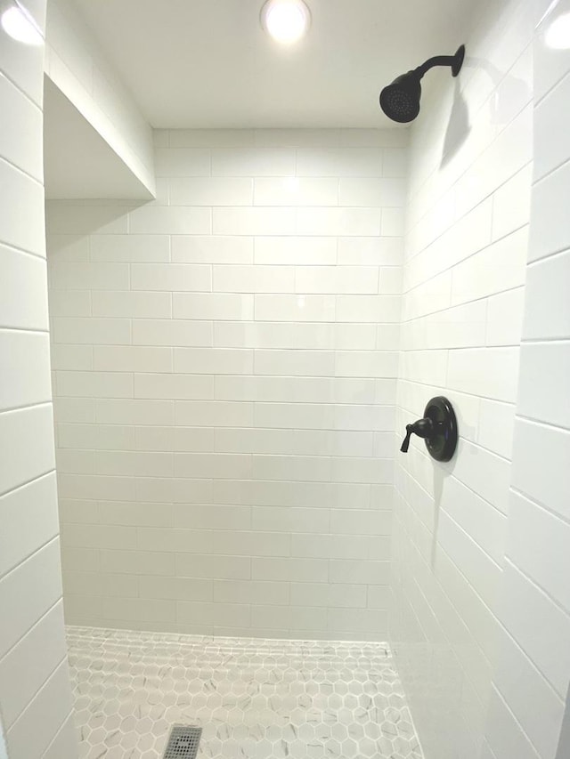 bathroom with recessed lighting and tiled shower