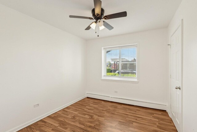 8440 Skokie Blvd Unit 102, Skokie, IL 60077 - unfurnished room featuring a baseboard radiator, wood finished floors, ceiling fan, and baseboards
