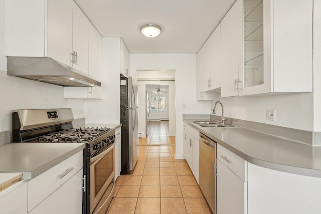8440 Skokie Blvd Unit 102, Skokie, IL 60077 - kitchen with stainless steel appliances, under cabinet range hood, a sink, white cabinetry, and light tile patterned flooring