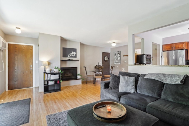 829 S Dwyer Ave Unit B, Arlington Heights, IL 60005 - living area featuring light wood-type flooring and a fireplace with raised hearth