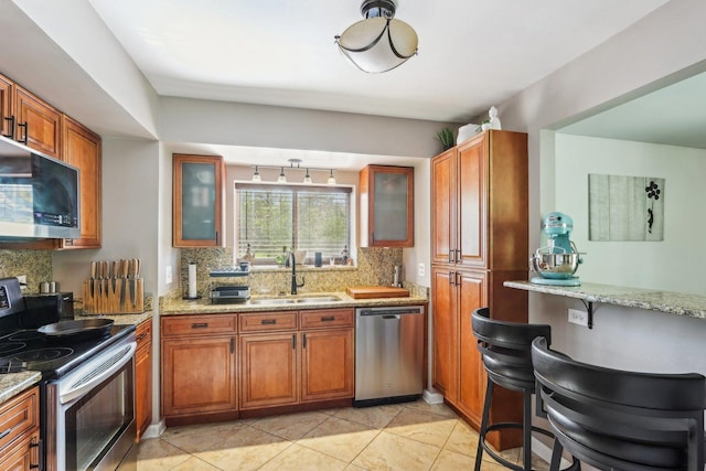 829 S Dwyer Ave Unit B, Arlington Heights, IL 60005 - kitchen with appliances with stainless steel finishes, backsplash, and brown cabinetry