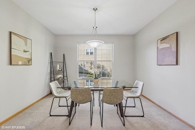 dining area with carpet floors and baseboards