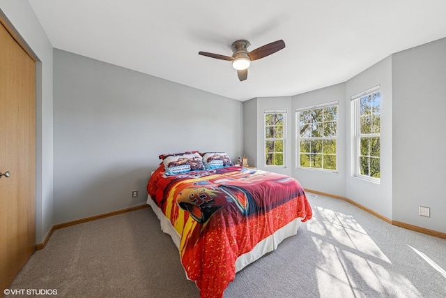 bedroom featuring carpet, baseboards, a ceiling fan, and a closet