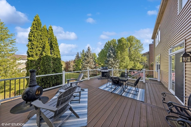 wooden terrace featuring a grill