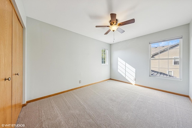 unfurnished bedroom featuring a closet, carpet floors, and baseboards