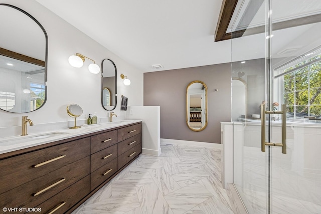bathroom featuring double vanity, baseboards, and a shower with door