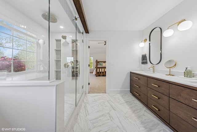 full bath featuring double vanity, a shower with door, ensuite bath, marble look tile flooring, and baseboards