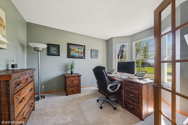 office space with light carpet and baseboards
