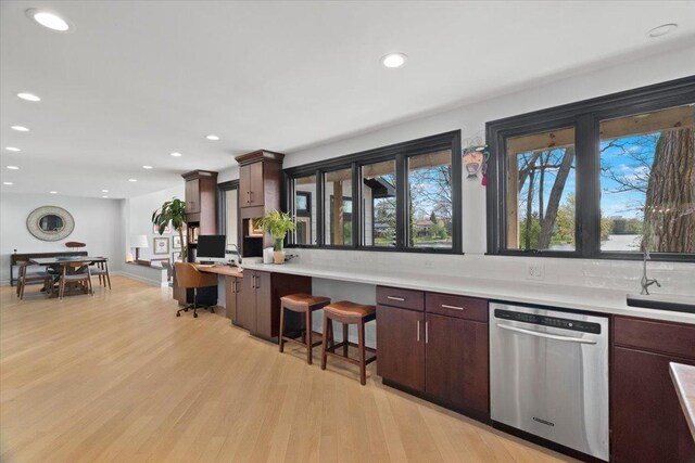 kitchen featuring light countertops, recessed lighting, light wood-style flooring, and dishwasher
