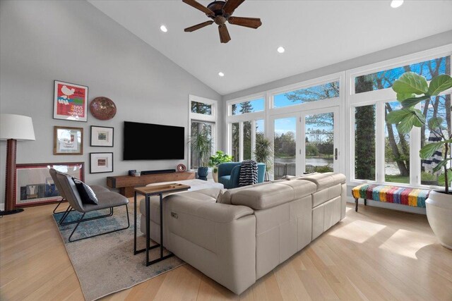 living room featuring a ceiling fan, high vaulted ceiling, recessed lighting, and light wood-style floors
