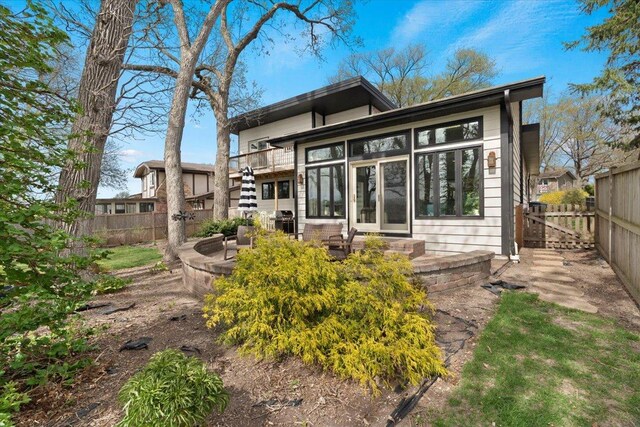 back of property featuring a fenced backyard and a patio area